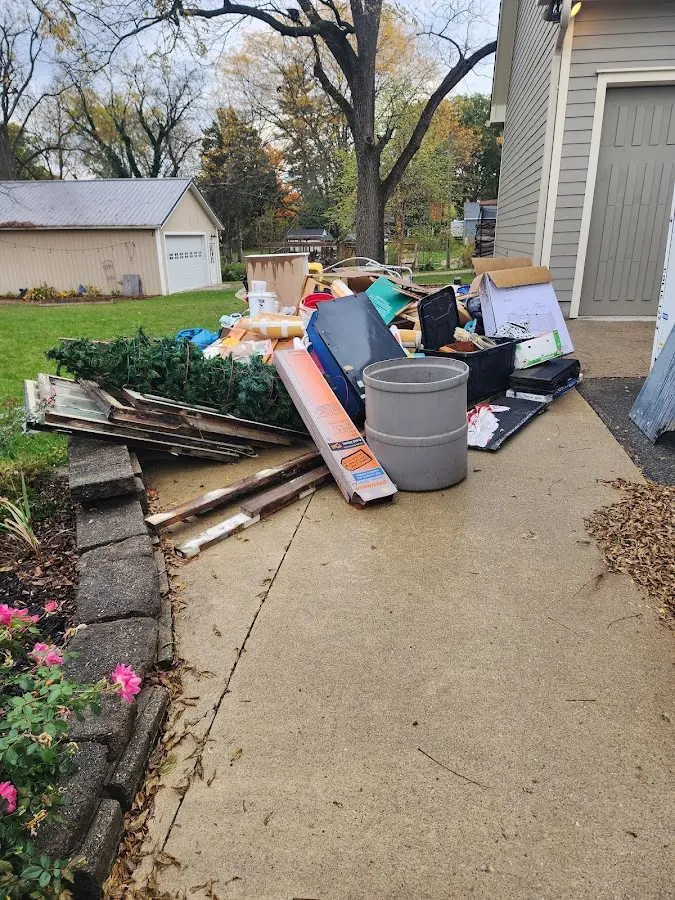 Dumpster being loaded with debris for Commercial Dumpster Rental in Ashburnham